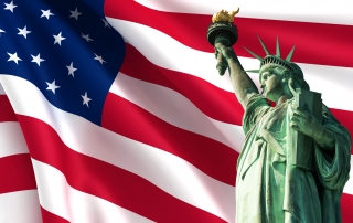 Statue of Liberty on the background of USA flag